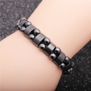 Men's magnetic hematite bead bracelet with square and round black stones worn on wrist