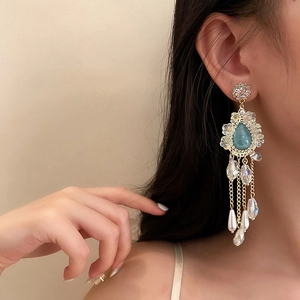 Elegant vintage flower tassel earrings with blue crystals and pearls on female model