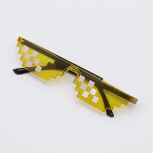 Detail of yellow pixelated sunglasses with transparent lenses and a Thug Life style design