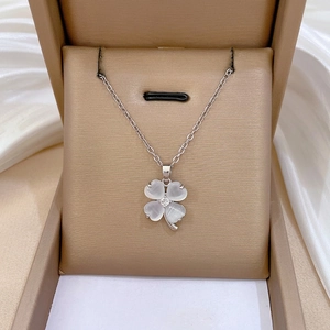 Titanium steel clover necklace with cat eye stone and sparkling crystals in a jewelry box