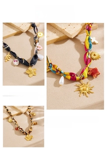 Detail of silk scarf necklaces with leopard print and golden sun heart pendants