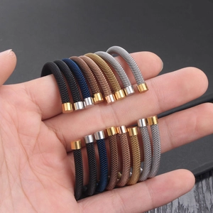 Mesh woven cable bracelets in five colors including black gold and silver on hand