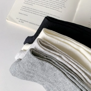 Breathable cotton crew socks in black, white, and grey with a soft knit texture