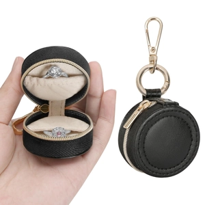 Macro view of portable mini round ring box with dual slots and golden zipper hook