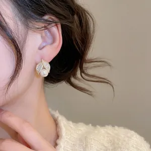 Elegant gold plated leaf stud earrings with sparkling zircons and white round pearls