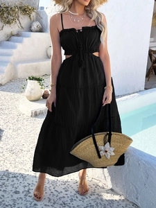 Full view of black bohemian tiered maxi dress with cutout waist and spaghetti straps