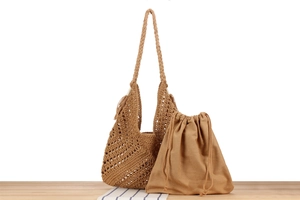 Detail of handmade woven triangle bag with brown drawstring inner pouch and net texture