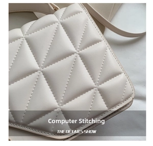 Gros plan d'un sac à main matelassé blanc crème avec coutures géométriques précises