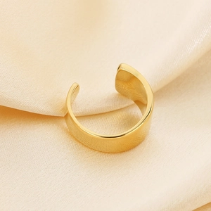 Minimalist wide band open ring in gold stainless steel on champagne silk background