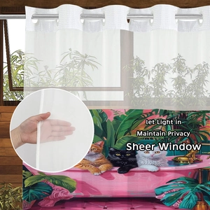 Detailed view of sheer upper window curtain and waterproof lower cat print shower curtain