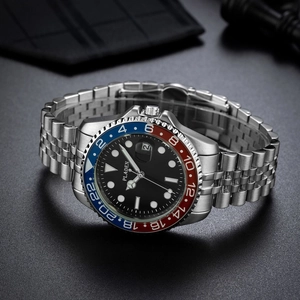 Close-up of stainless steel business watch with red and blue bezel and date window