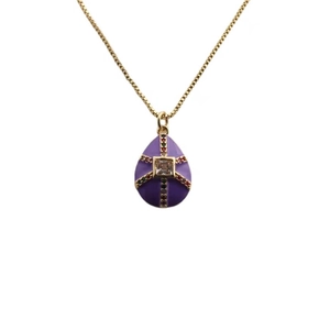 Golden chain necklace with purple enamel egg pendant and square clear gemstone