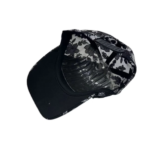 Detail view of the black baseball cap interior with floral embroidery and adjustable strap