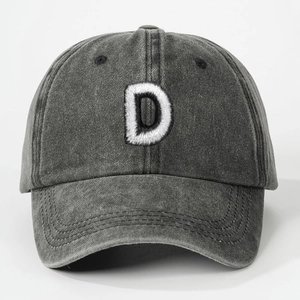 Close-up of white letter D 3D embroidery on washed dark grey cotton baseball cap