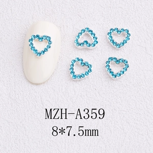 Detail view of 8x7.5mm silver heart nail charms with blue rhinestones and MZH-A359 code
