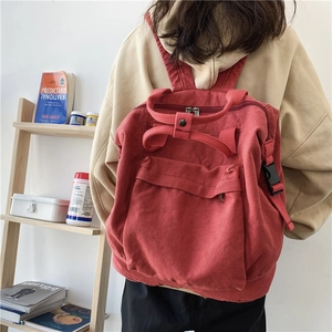 Red canvas backpack for women with top handles and adjustable straps in a casual style