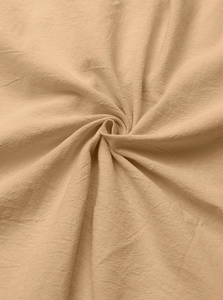 Detailed macro view of natural cotton and linen fabric texture in beige showing fiber weave