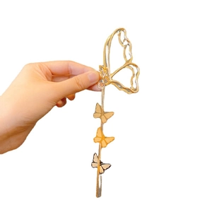 Golden butterfly hair claw clip with tassel pendants and hollow metal frame design
