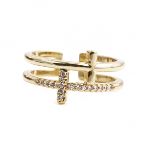 Detailed close-up of golden hollow double cross ring with micro-set cubic zirconia stones