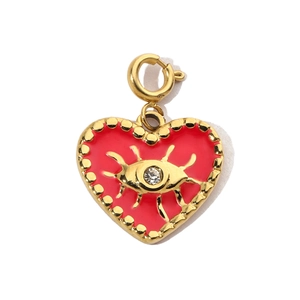 Close-up of heart charm with red enamel, evil eye pattern, and gold clasp detail