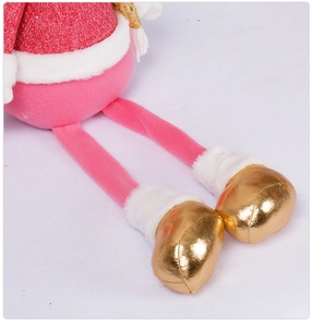 Detail of plush Christmas doll legs with pink fabric, gold feet, and white fur trim