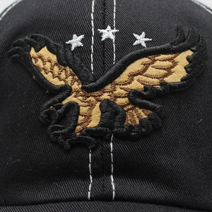 Detailed close-up of eagle embroidery and white stars on black cotton baseball cap