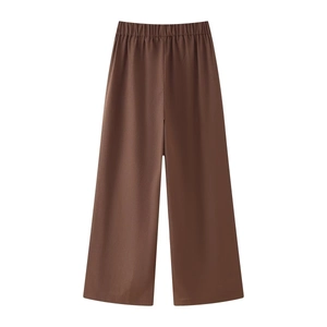 Detailed view of dark brown linen wide-leg trousers with elastic waistband and smooth drape