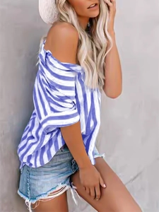 Detail of blue and white striped off-shoulder shirt paired with casual denim shorts