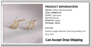 Detail view of gold-plated copper music note earrings with zircon and size specifications
