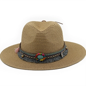 Detail of handmade straw fedora featuring ethnic embroidery and turquoise bead accents