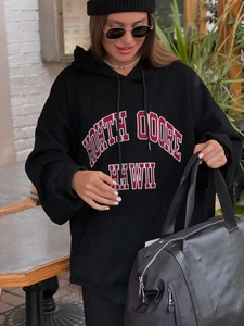 Close-up of North Shore Hawaii lettering on black heavy fleece hoodie during outdoor photoshoot