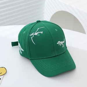 Detail of green cotton kids baseball cap featuring white dinosaur skeleton embroidery