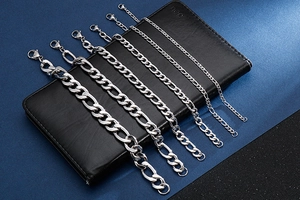 Detail view of five different widths of silver stainless steel curb chain bracelets