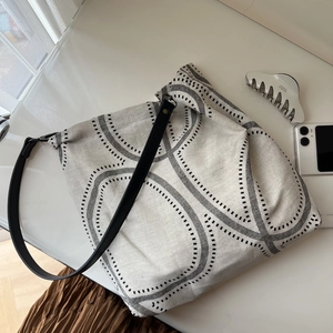 Minimalist cotton linen tote bag with black geometric circle print and wide shoulder strap