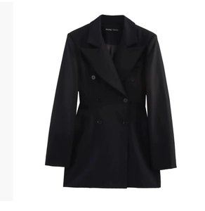 Detail shot of black satin blazer featuring shoulder pads and luxury interior brand label