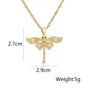 Detail view of gold dragonfly pendant with zircon inlay showing 2.7cm x 2.9cm dimensions
