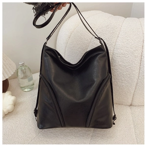 Detail view of the black PU leather shoulder bag featuring symmetrical V-zipper accents