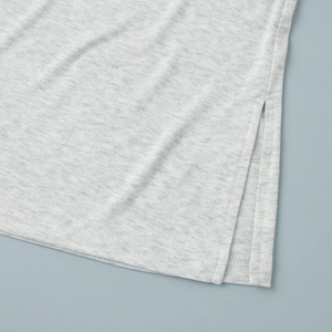 Detail shot of light gray melange knit fabric showing premium side slit and double stitching