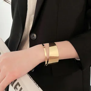 Minimalist wide gold irregular cutout open bangle with polished mirror finish for women