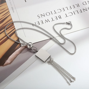 Minimalist 18K gold plated stainless steel square bead tassel necklace on magazine