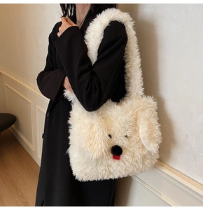 Detail of white fluffy plush tote bag with cute dog face design and soft furry texture
