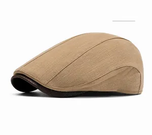 Detailed close-up of khaki linen flat cap with vintage texture and leather brim detail