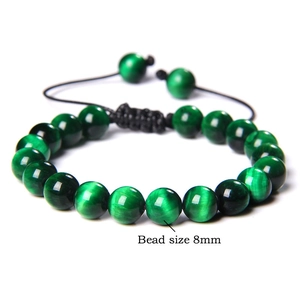 Close-up of 8mm green tiger eye beaded bracelet with adjustable black braided cord