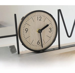 Detail of creative HOME letter clock with black metal frame and wooden dial texture