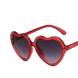 Sparkly red heart-shaped sunglasses for kids with glitter frame and grey gradient lenses