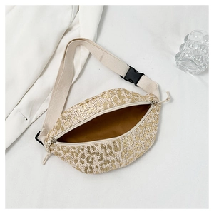 Detail of straw waist bag with golden leopard pattern and black plastic buckle