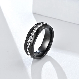 Detail of black titanium ring featuring a brushed finish and inlaid white cubic zirconia stones