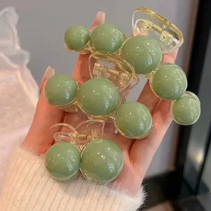 Three-piece bean green pearl hair claw clip set with transparent acrylic and metal spring