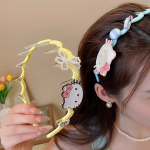 Detail of Hello Kitty fabric headbands with pearls and cute bows in blue and yellow