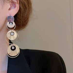 Detail of long layered round disc drop earrings with sparkling zircon micro-inlay